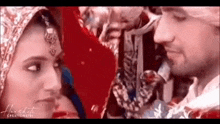 a bride and groom are looking at each other in a close up of their faces .