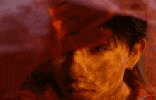 a close up of a man 's face with a red background