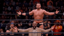 a wrestler in a ring with his arms outstretched