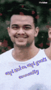 a man wearing a white shirt that says ' capt and co. capt guts community ' on it
