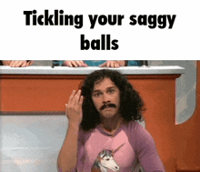 a man with a mustache and a unicorn shirt is tickling his saggy balls