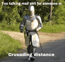 a knight in armor is walking down a dirt road with a sword .
