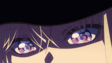 a close up of a person 's eyes with a black hat on