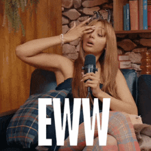 a woman singing into a microphone with the word eww on the bottom right