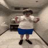 a person standing in a hallway with a tik tok watermark