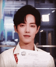 a man in a white shirt is holding a piece of paper that says 80000 on it