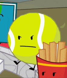 a tennis ball with an angry face is standing next to a french fries container