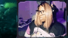 a woman wearing headphones and a cat ear headband is sitting in front of a computer screen .
