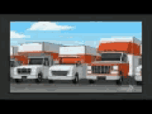 a row of moving trucks are parked in a lot