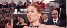 a woman is making a funny face and saying i 'm starving while standing next to a man .