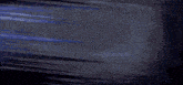 a white robot with a pink nose is flying through the air in a dark room .