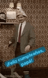 a man in a suit and tie is dancing in a room with a hat on .
