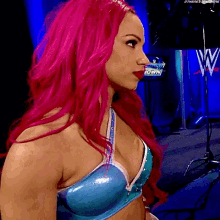 a woman with pink hair is wearing a blue bra