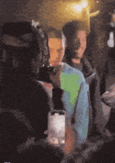 a group of people are gathered in a dark room