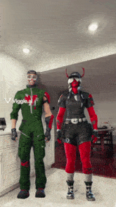 a man and a woman are standing next to each other in a kitchen and the woman is wearing a red outfit with horns