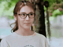 a woman wearing glasses is wearing a shirt that says good time