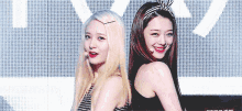 two women are standing next to each other and one has a headband on her head