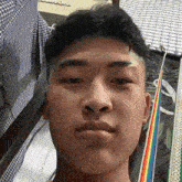 a close up of a man 's face with a rainbow in the background .