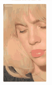 a close up of a woman 's face with her eyes closed and pink lips