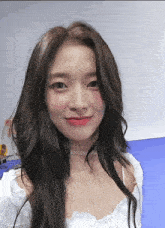 a close up of a woman 's face with long hair and a choker .