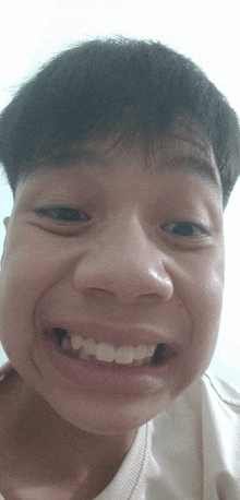 a close up of a young man 's face with a smile on his face