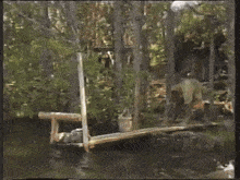 a person in a yellow shirt is falling into a body of water .