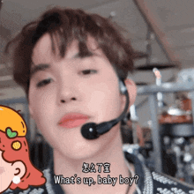 a man with a microphone on his head says what 's up baby boy
