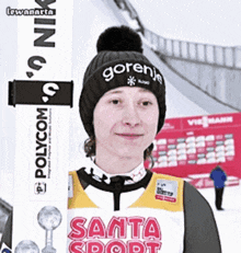 a woman wearing a gornje hat and a santa sport shirt