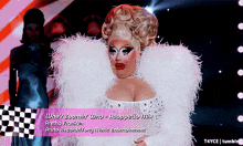 a drag queen with feathers on her sleeves and the words who 's zoomin ' who