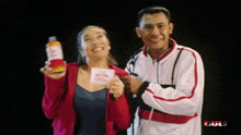 a man and a woman are posing for a picture with a bull logo in the corner