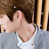 a close up of a person 's neck and ear with a red arrow pointing to the right