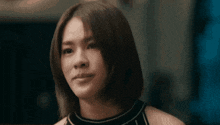 a woman with short hair is looking at the camera