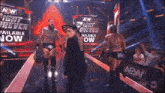 two wrestlers on a stage with a sign that says " aew "