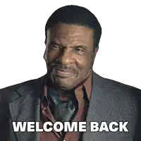 a man in a suit and tie is smiling and says welcome back