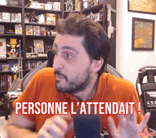 a man sitting in front of a microphone with the words personne l' attendait written on the bottom