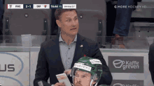 a hockey game is being played with a man wearing a helmet that says ' burfors ' on it