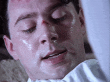 a close up of a man 's face with sweat coming out of it