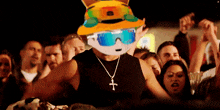 a man wearing sunglasses and a necklace with a cross