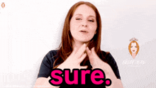 a woman in a black shirt is making a gesture that says sure