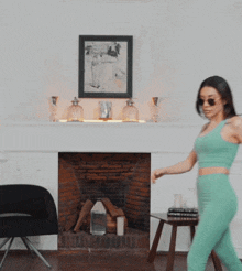 a woman wearing sunglasses and a crop top throws a pillow in the air