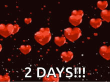 a bunch of red hearts floating in the air with the words `` 2 days '' .