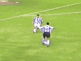 a group of soccer players on a field with an advertisement for lolo in the background