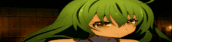 a close up of a green haired anime girl 's face in a dark room .