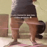 a person is standing in front of a vacuum cleaner with their legs crossed .