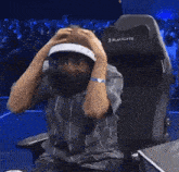 a man is sitting in a blackly gaming chair with his mouth open