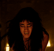 a close up of a woman with her eyes closed and her mouth open