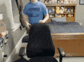 a man wearing a blue shirt that says ' nba ' on it