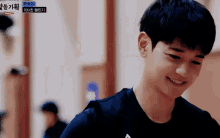 a young man is smiling in front of a sign that says 10 on it