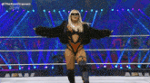 a woman in a fur coat is standing in a wrestling ring with her arms outstretched