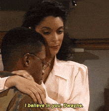 a man and a woman are hugging and the woman says i believe in you dwayne